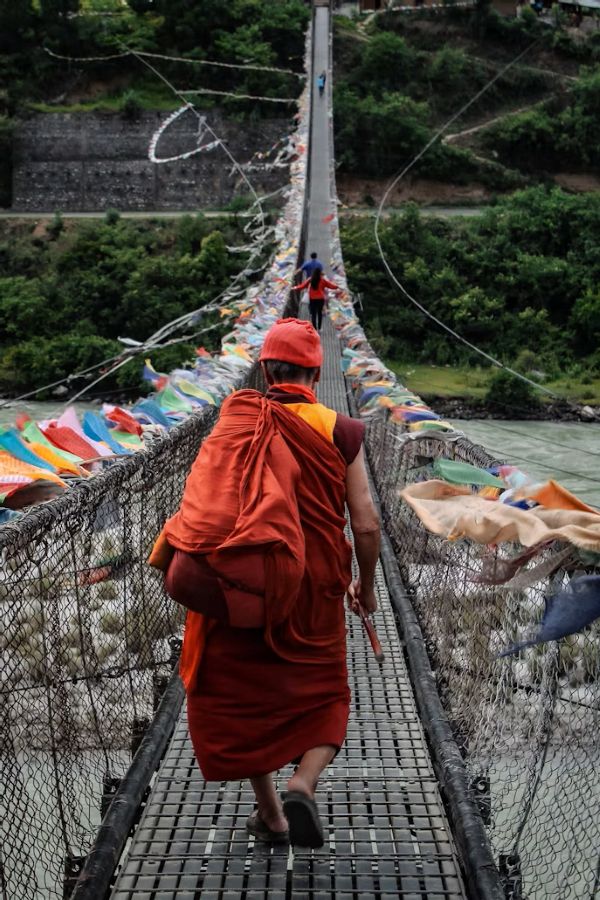 A monk crossing the Punakha suspension bridge