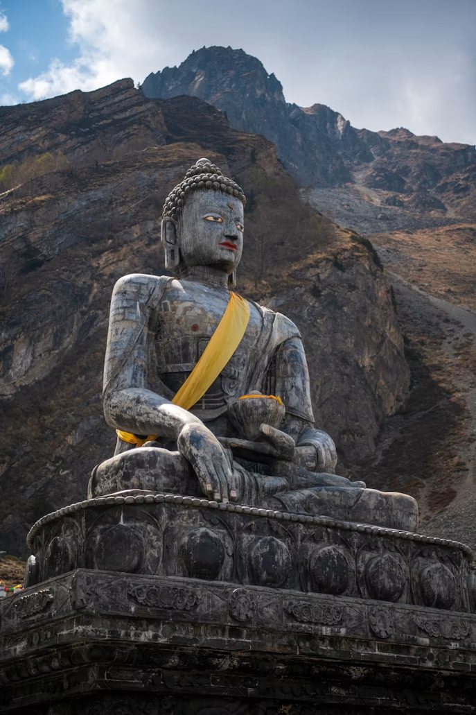 Buddha statue at Muktinath with the Himalaya